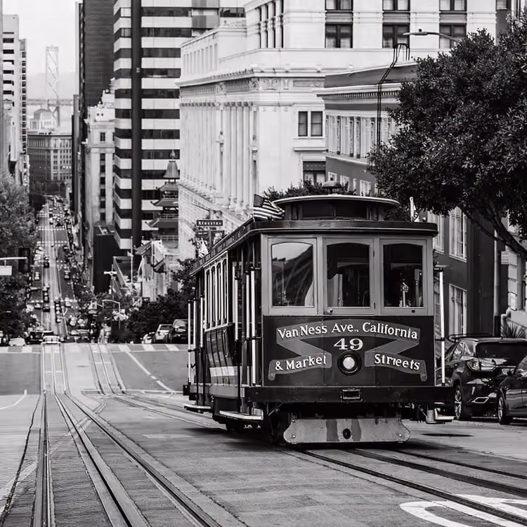 San Francisco cable car traveling down a steep downtown street in California.