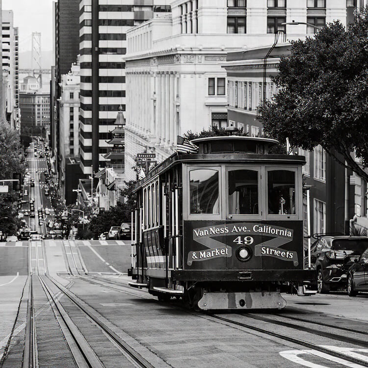San Francisco cable car traveling down a steep downtown street in California.