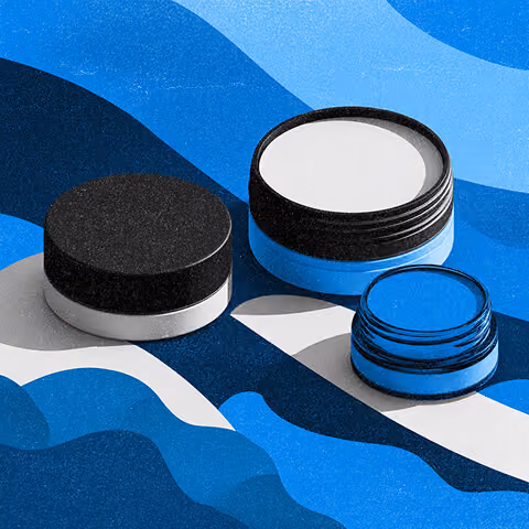 Minimal product packaging containers arranged on abstract blue shapes, representing evaluation of brand packaging and visual identity.