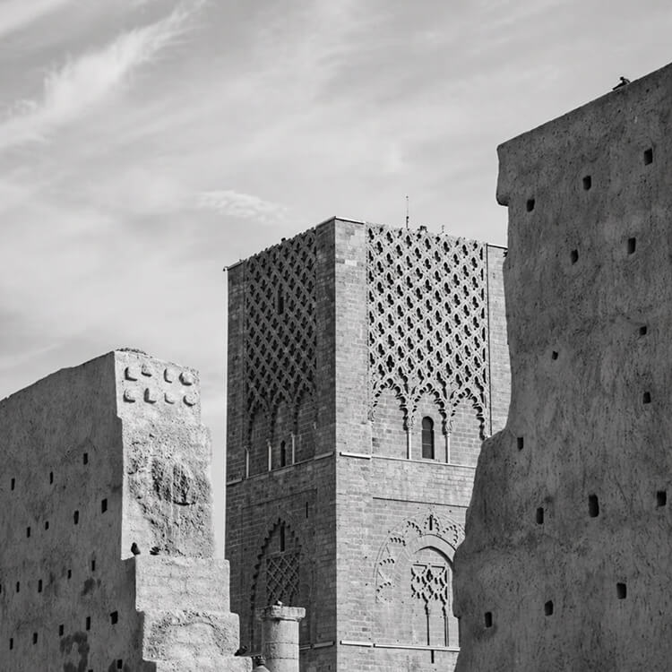 Black and white view of Bahrain Fort with historic stone architecture and traditional design details.