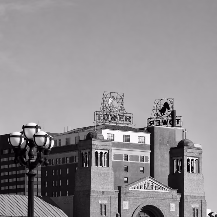 Black and white image of the historic Tower Theatre building in downtown Phoenix with rooftop signage.