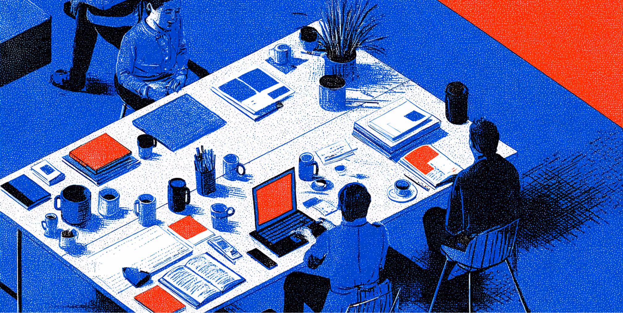 Team gathered around a desk with laptops, notebooks, and design materials, representing collaboration and strategic brand development.