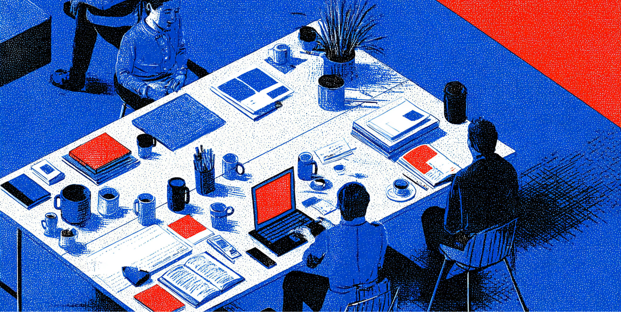 Team gathered around a desk with laptops, notebooks, and design materials, representing collaboration and strategic brand development.