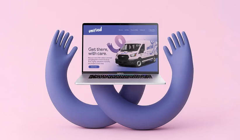 Laptop held by abstract hands displaying a branded website, representing digital experience and brand application.