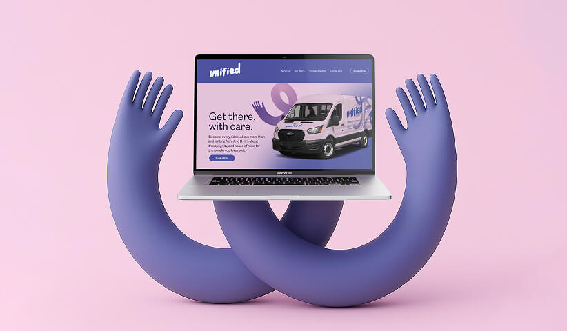 Laptop held by abstract hands displaying a branded website, representing digital experience and brand application.