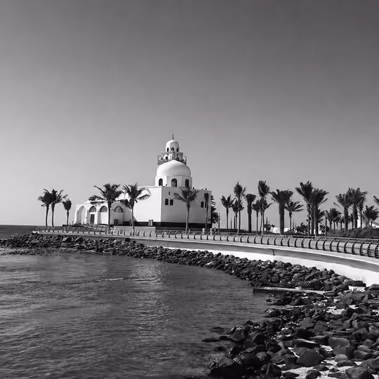 Jeddah waterfront mosque along the Red Sea with palm-lined promenade in Saudi Arabia.