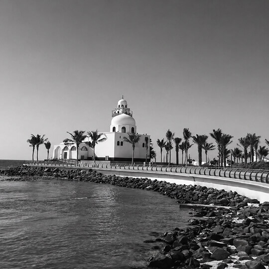 Jeddah waterfront mosque along the Red Sea with palm-lined promenade in Saudi Arabia.