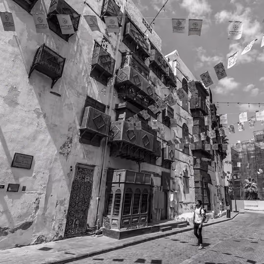 Historic Al-Balad street in Jeddah featuring traditional buildings with wooden balconies and cultural architecture.