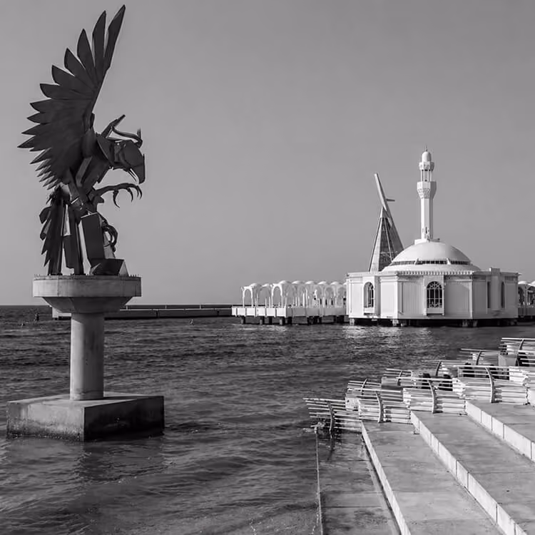 Jeddah waterfront with King Fahd Fountain area and coastal promenade featuring public art sculpture.