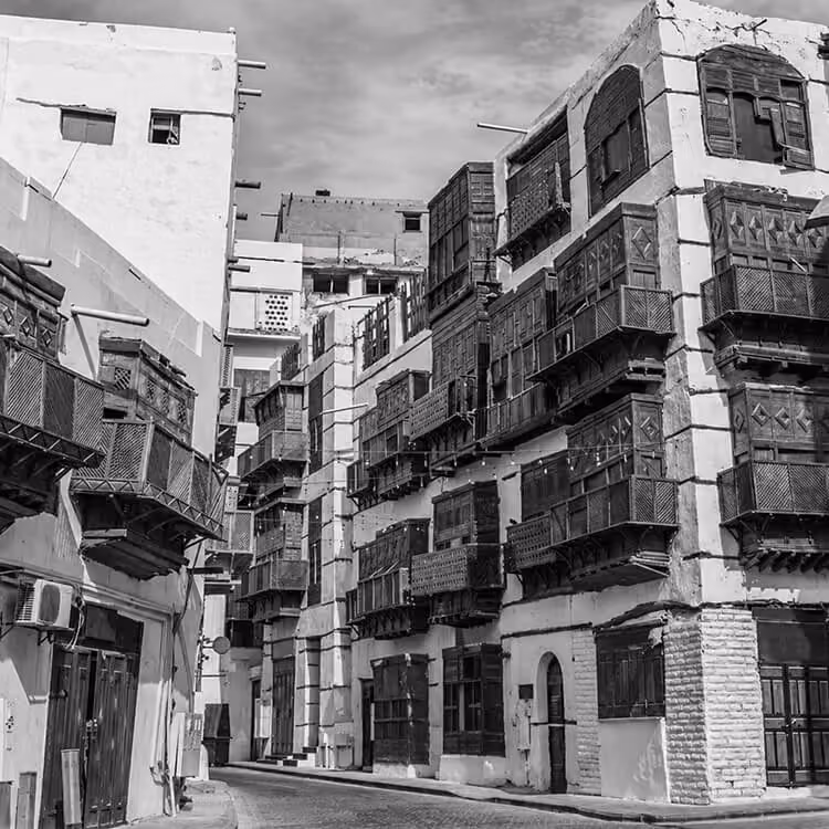 Al-Balad historic district in Jeddah with traditional buildings and wooden mashrabiya balconies.