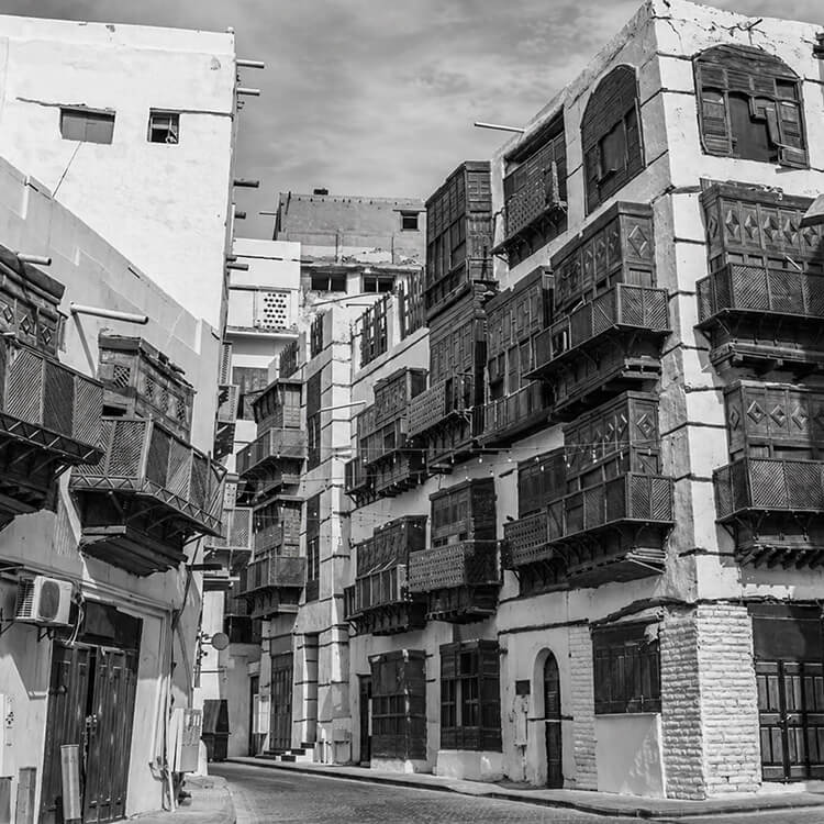 Al-Balad historic district in Jeddah with traditional buildings and wooden mashrabiya balconies.