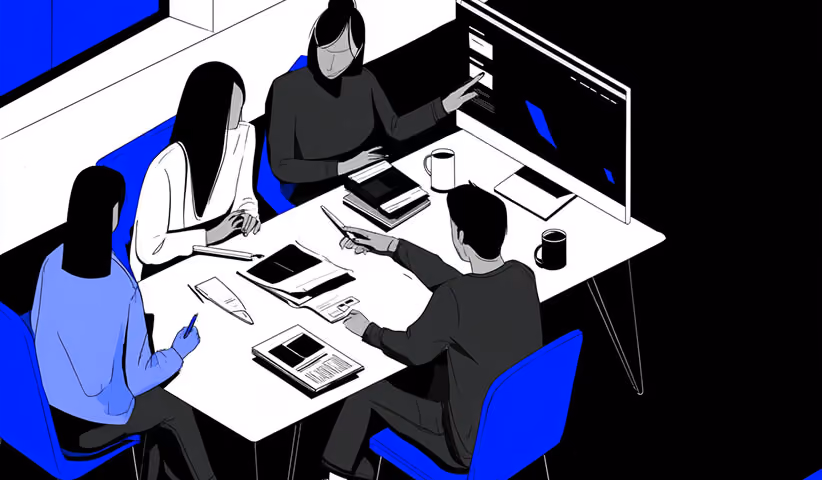 Team gathered around a desk reviewing design concepts on screens and paper, representing collaborative logo development.