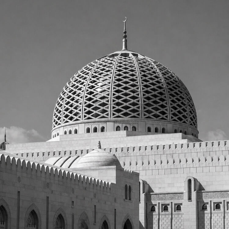 Close-up of mosque dome in Muscat featuring intricate geometric patterns and Islamic architecture.