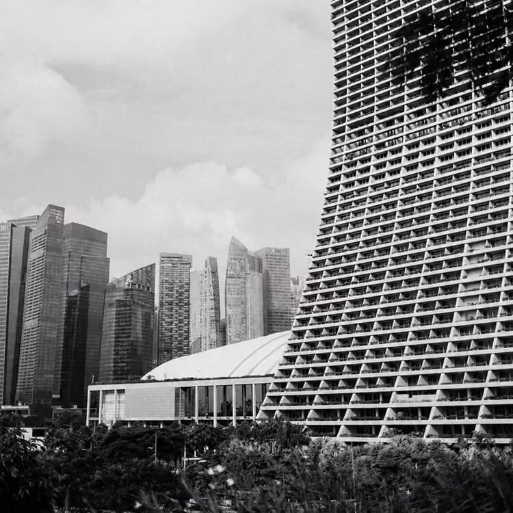 Modern Singapore architecture with high-rise buildings and geometric urban design.