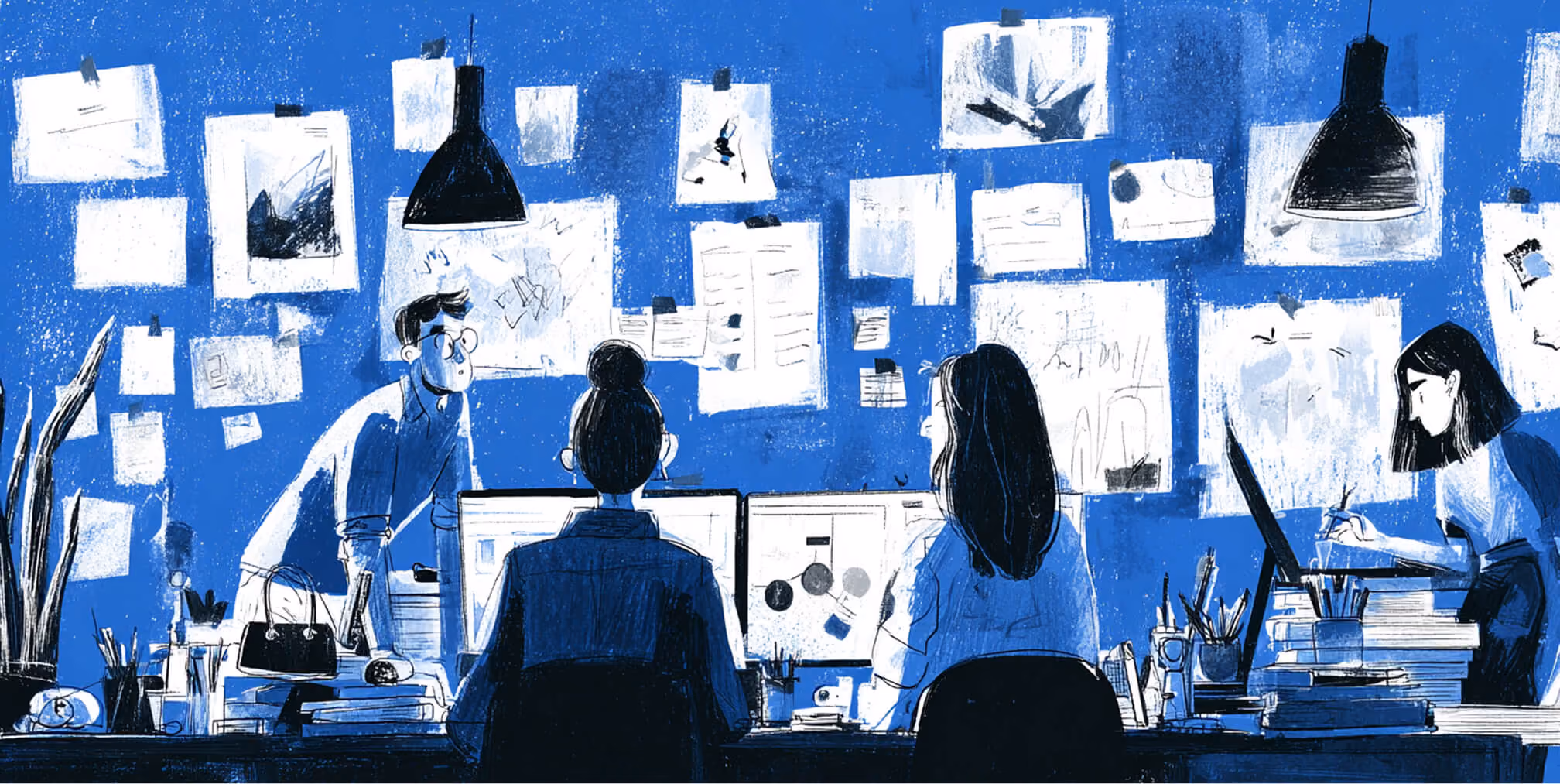 Creative team working together in a studio with walls covered in sketches and notes, representing collaboration and full-service branding execution.