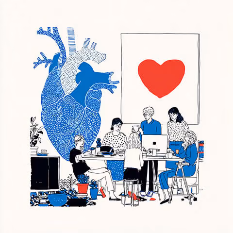Creative team collaborating around a desk beneath a large heart illustration and anatomical artwork, representing community-driven branding and collaborative marketing strategy.
