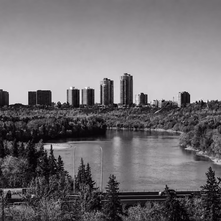 North Saskatchewan River flowing through Edmonton with residential towers along the skyline.