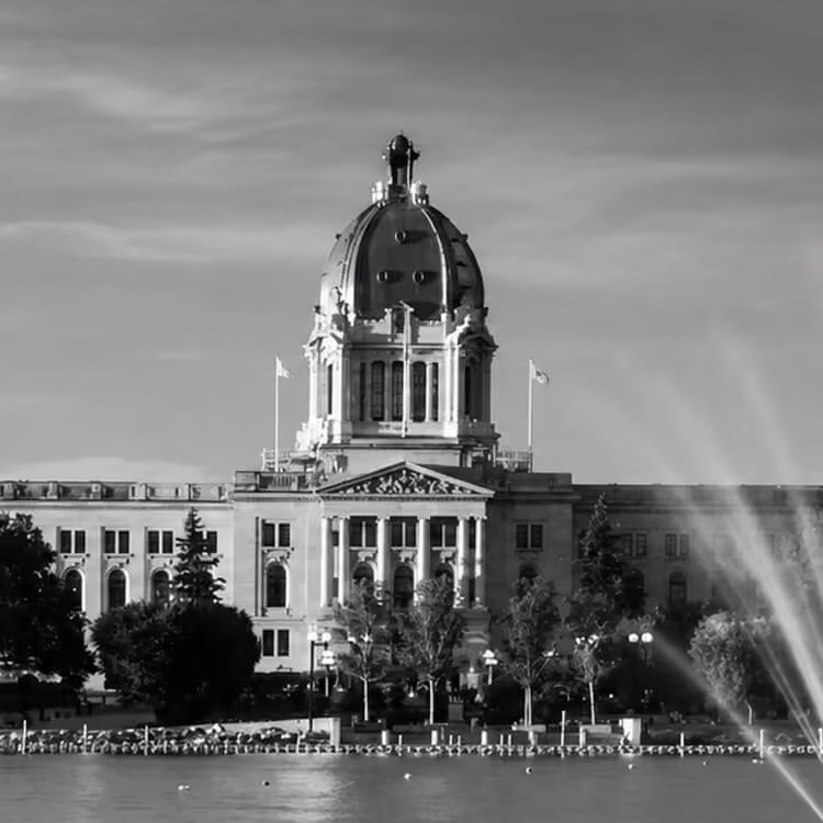 The Saskatchewan Legislative Building reflected across Wascana Lake in Regina.