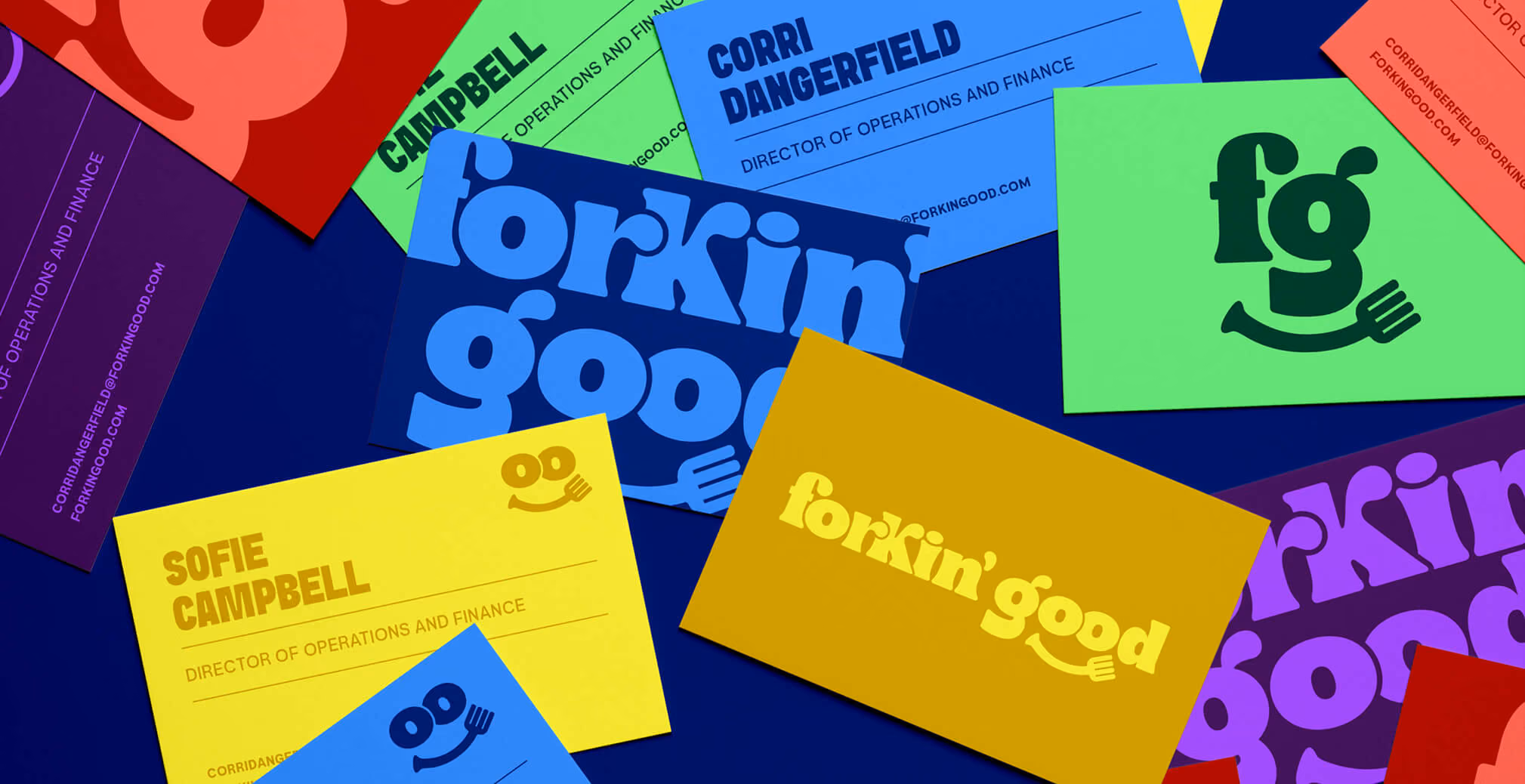 Colorful Forkin’ Good business cards and branding materials arranged in an overlapping flat lay featuring bold typography, playful logo applications, and vibrant brand colors.