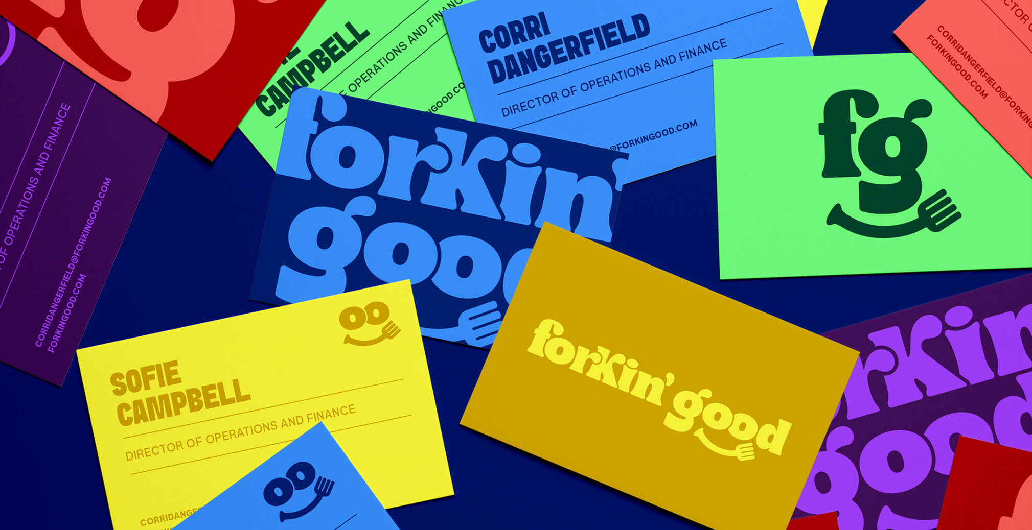 Colorful Forkin’ Good business cards and branding materials arranged in an overlapping flat lay featuring bold typography, playful logo applications, and vibrant brand colors.
