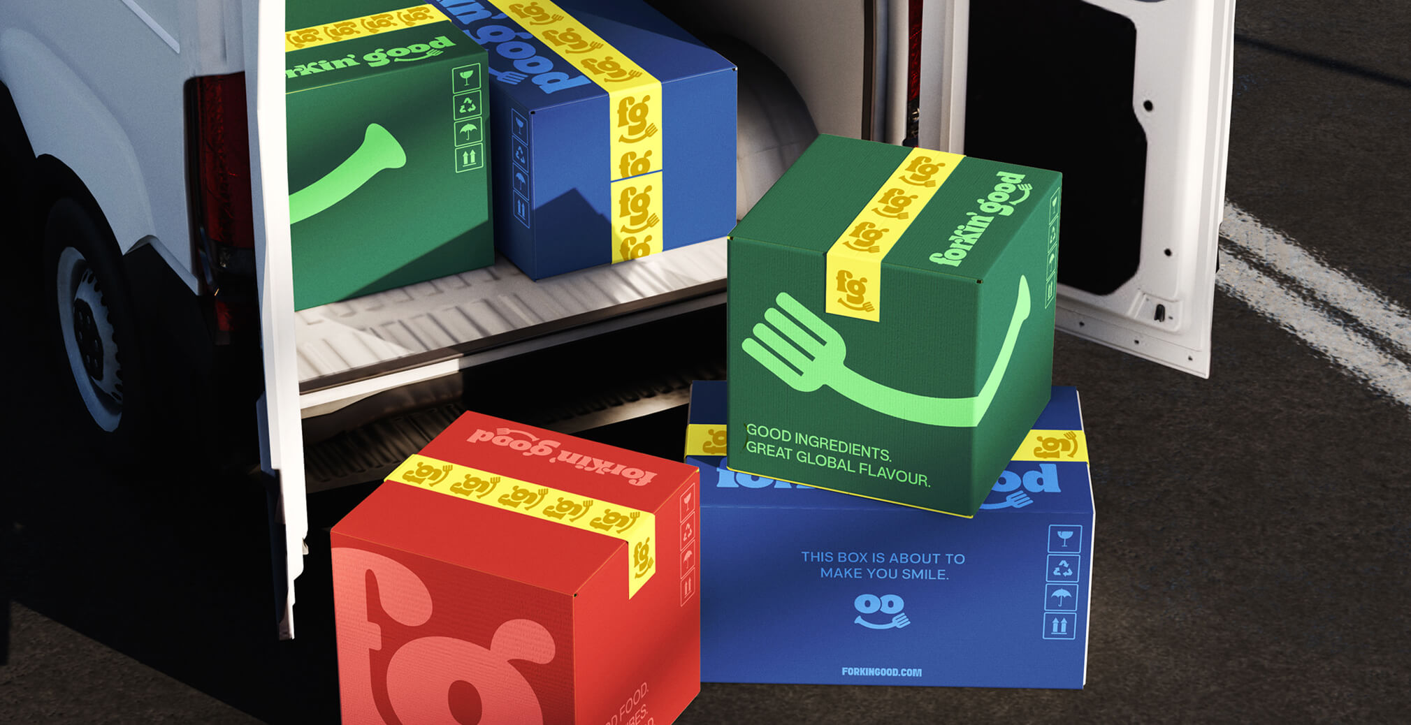 Stack of colorful Forkin’ Good branded shipping boxes placed at the back of a delivery van, featuring playful illustrations and bold packaging graphics.