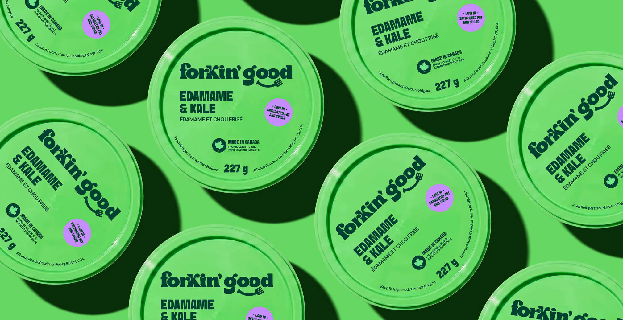 Pattern-style product packaging layout featuring multiple bright green Forkin’ Good Edamame & Kale containers arranged across a matching green background, highlighting bold black typography and playful modern food branding.