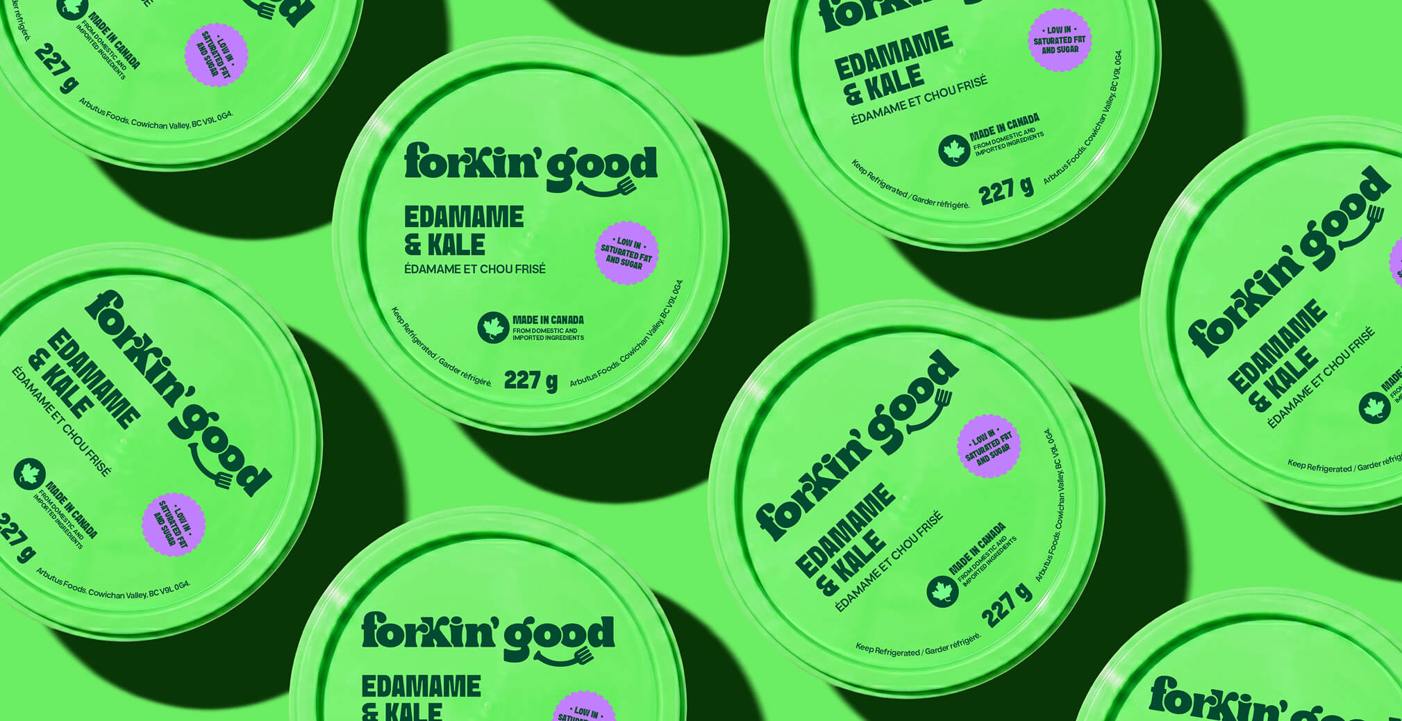 Pattern-style product packaging layout featuring multiple bright green Forkin’ Good Edamame & Kale containers arranged across a matching green background, highlighting bold black typography and playful modern food branding.