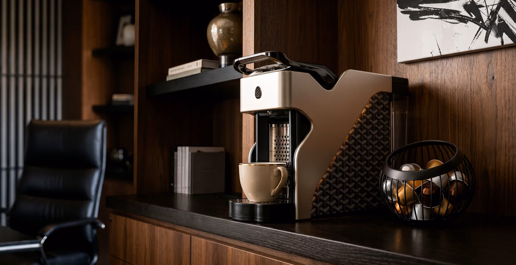 Luxury Milton Coffee machine positioned on a dark wood shelf in an executive office, showcasing premium materials, modern craftsmanship, and elegant product design.