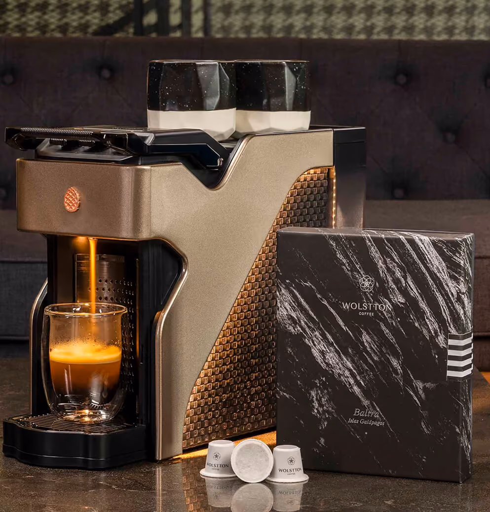 Milton Coffee machine showcased alongside branded coffee packaging and capsules, highlighting luxury product presentation and premium coffee offerings.