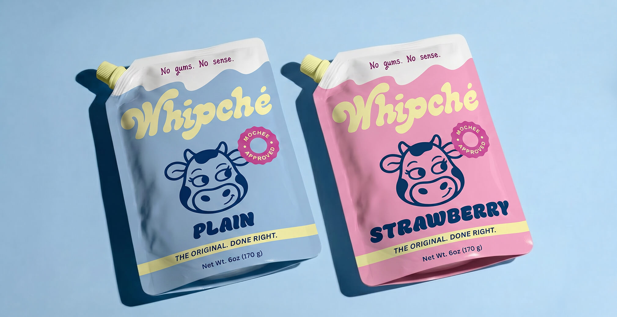 Whipché plain and strawberry cream cheese pouches displayed against a pastel blue background, showcasing vibrant packaging and product branding.