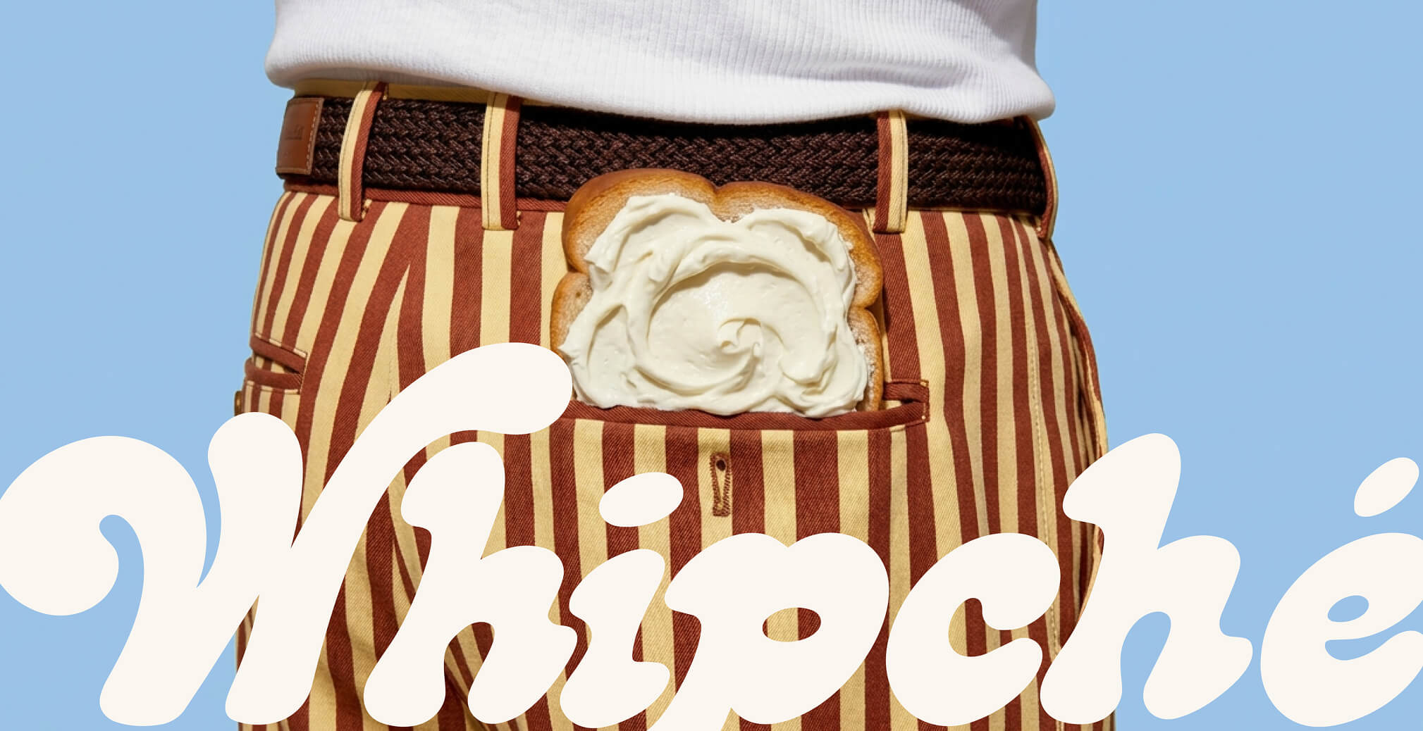 Slice of toast topped with cream cheese tucked into striped trousers, creating a whimsical lifestyle image for the Whipché brand campaign.