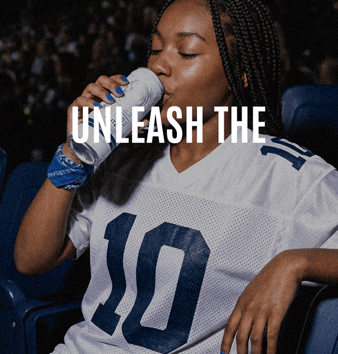 Sports fan enjoying Whiteout Blitz canned tequila cocktail while watching a football game, reinforcing brand lifestyle positioning, event marketing, and the spirit of celebration.