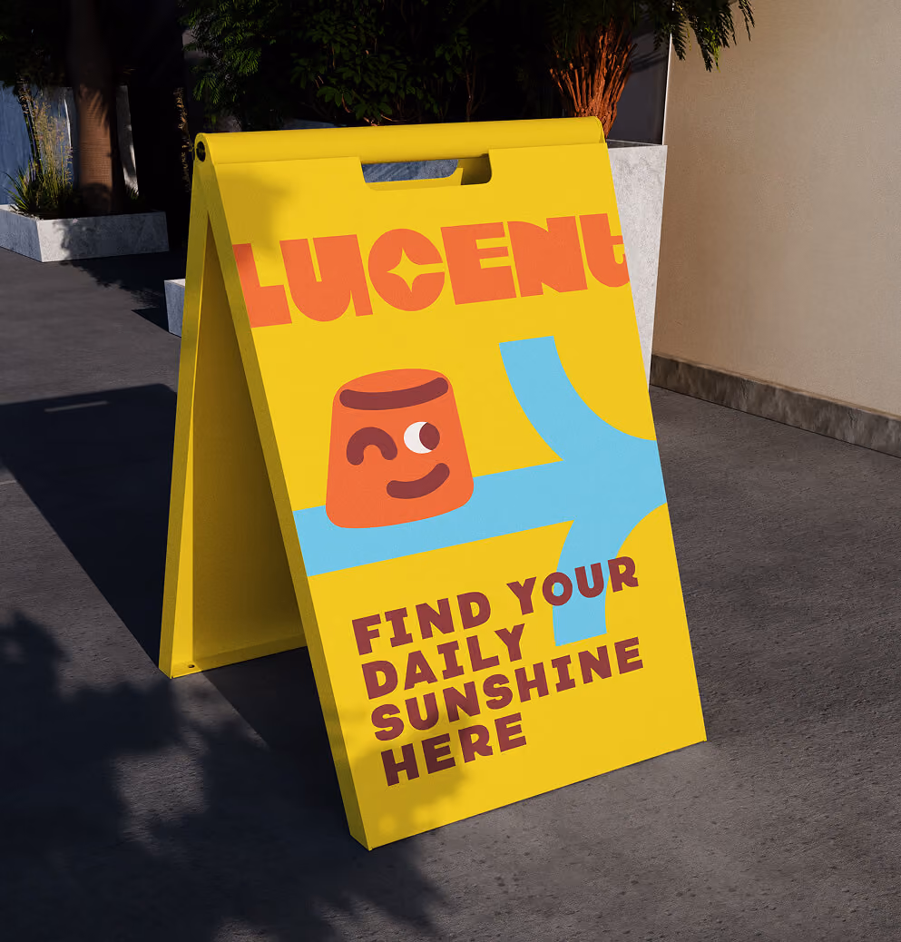 Yellow Lucent Sun sidewalk sign featuring a cheerful character illustration and the message “Find Your Daily Sunshine Here” outside a storefront.