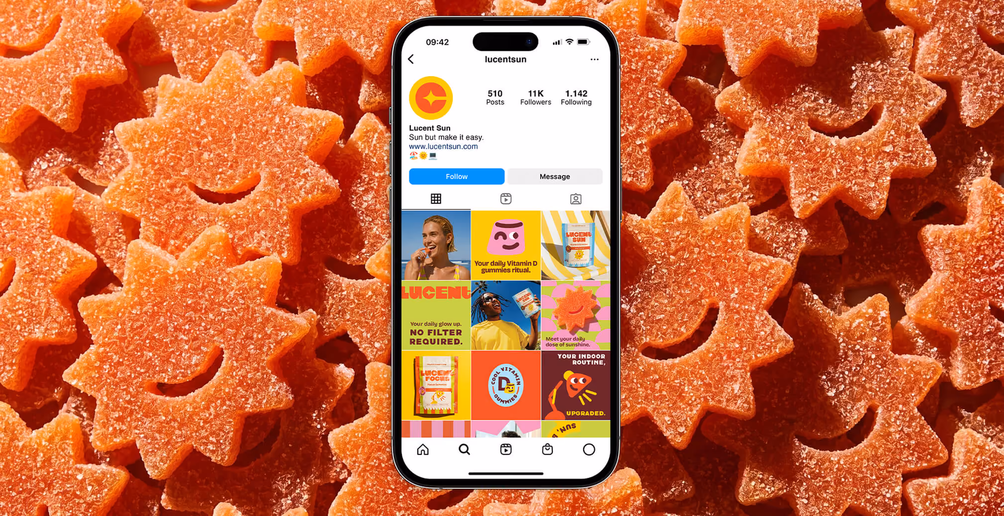 Smartphone displaying the Lucent Sun Instagram profile over a background of orange sun-shaped gummies, showcasing the brand’s colorful social media content.