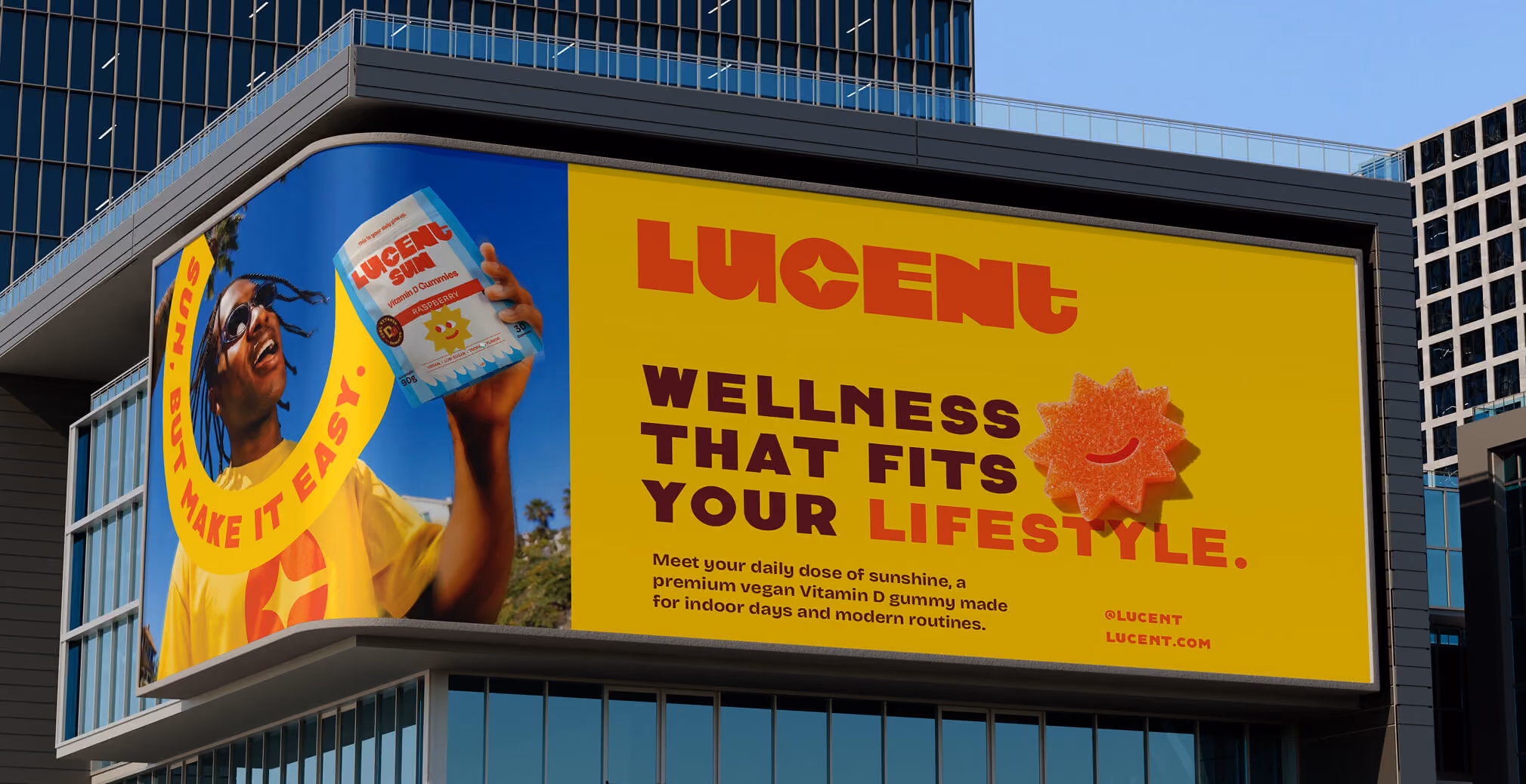 Large urban billboard promoting Lucent Sun Vitamin D Gummies with lifestyle photography, vibrant yellow branding, smiling gummy graphics, and wellness-focused messaging.