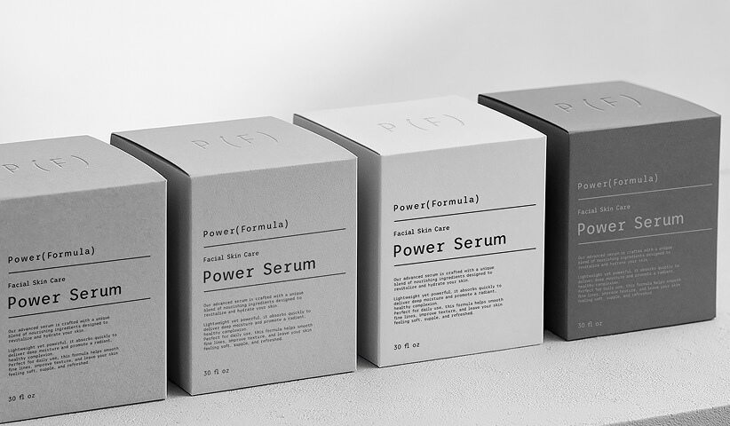 Collection of minimalist skincare serum boxes arranged in a monochromatic presentation, showcasing consistent packaging design that strengthens brand recognition across a product line.