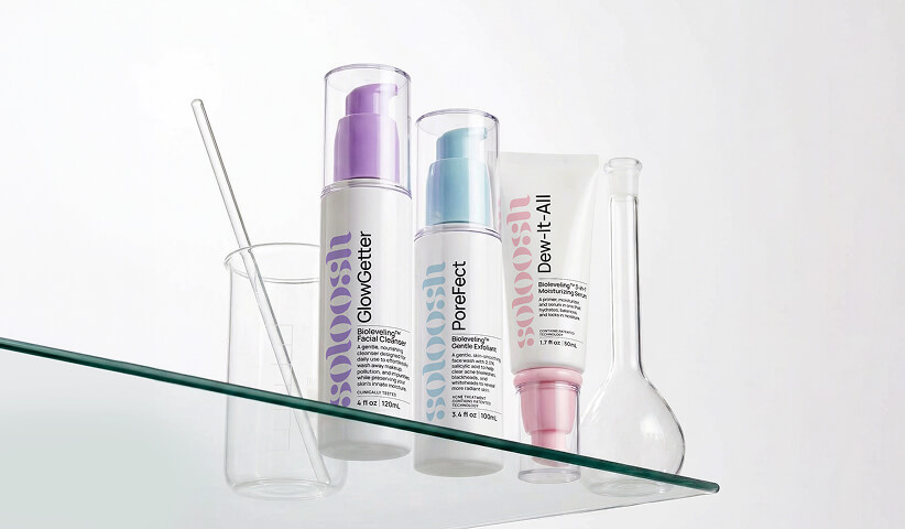 Skincare products displayed alongside laboratory glassware, representing packaging design that balances scientific credibility, product efficacy, and contemporary aesthetics.