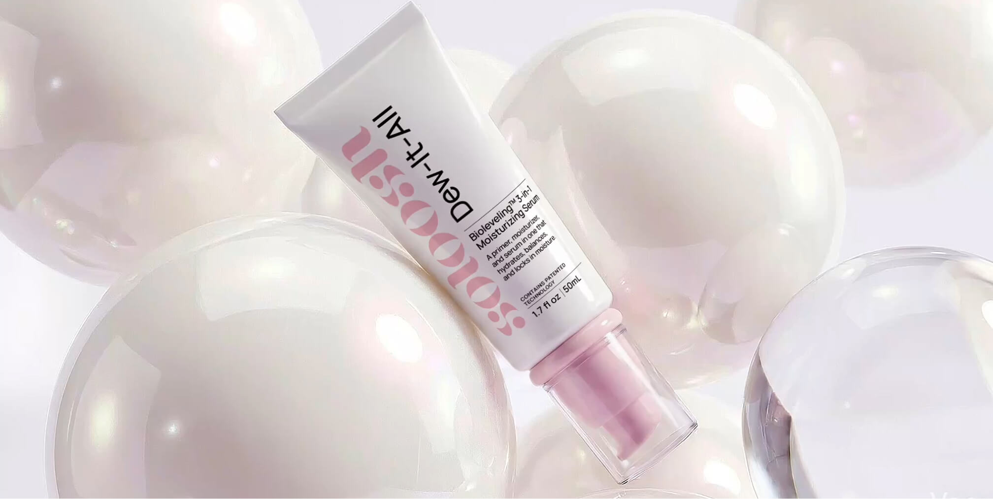 Moisturizing skincare serum displayed among iridescent spheres, showcasing packaging design that creates a premium beauty identity while emphasizing hydration, softness, and product performance.