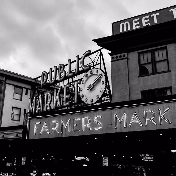 Image 02 Historic entrance to Seattle’s Pike Place Market featuring the famous Public Market clock and Farmers Market sign.