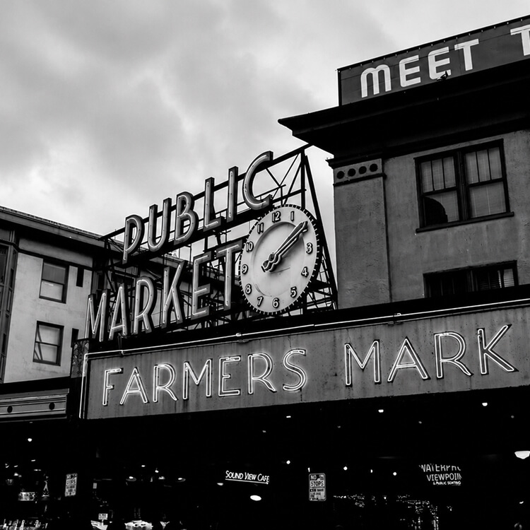 Image 02 Historic entrance to Seattle’s Pike Place Market featuring the famous Public Market clock and Farmers Market sign.
