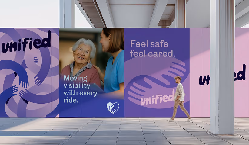Large-format branded wall graphics transforming a public interior space with consistent messaging, photography, and visual identity, showcasing environmental graphic design for corporate branding.