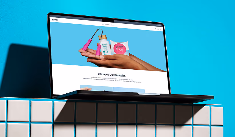 Laptop displaying an oral care Shopify storefront with featured products and clean interface, representing responsive ecommerce website design and optimized online shopping experiences.