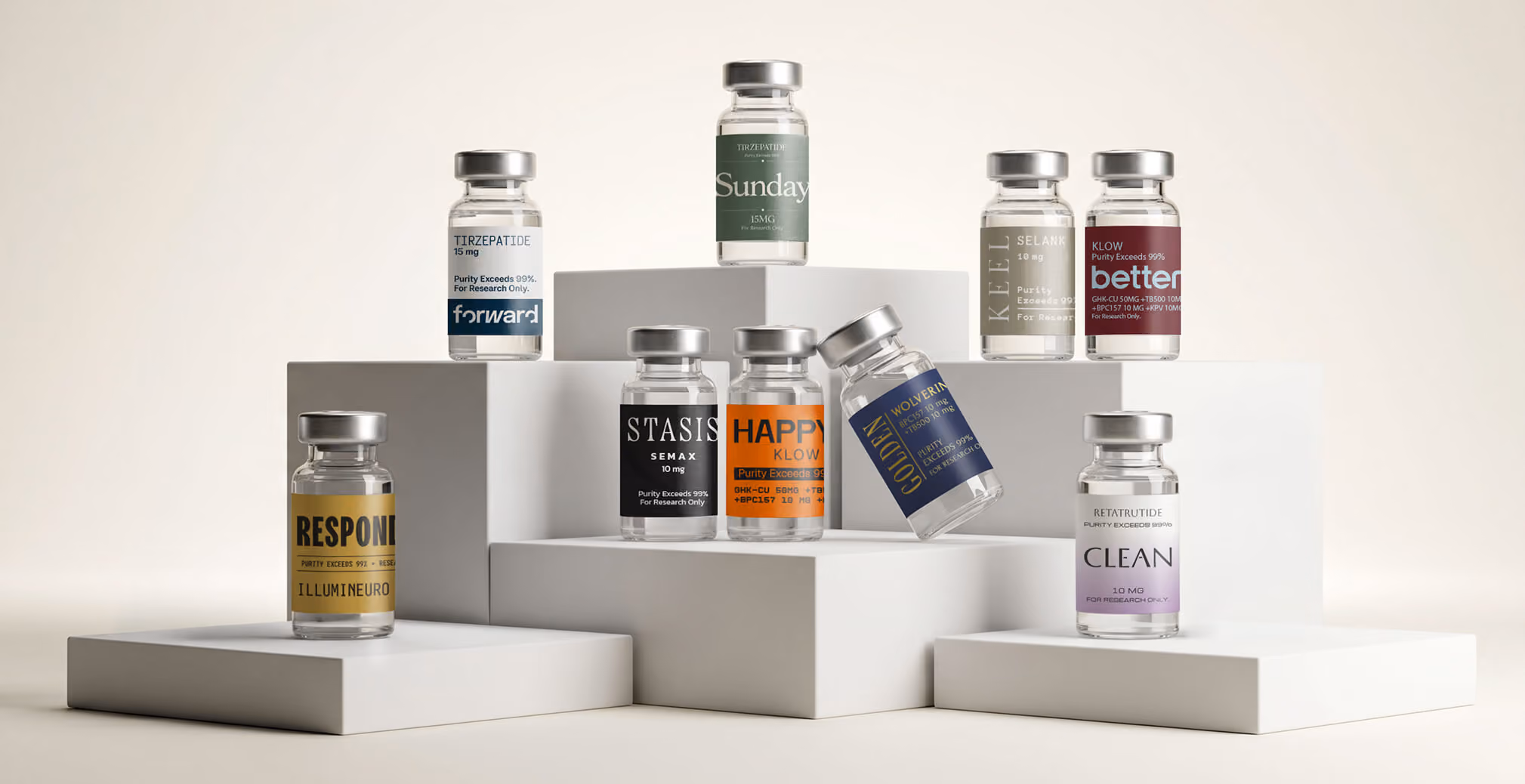 Collection of branded peptide and wellness supplement vials displayed on minimalist white podiums, showcasing a premium packaging system with distinctive labels, modern typography, and color-coded product identities.