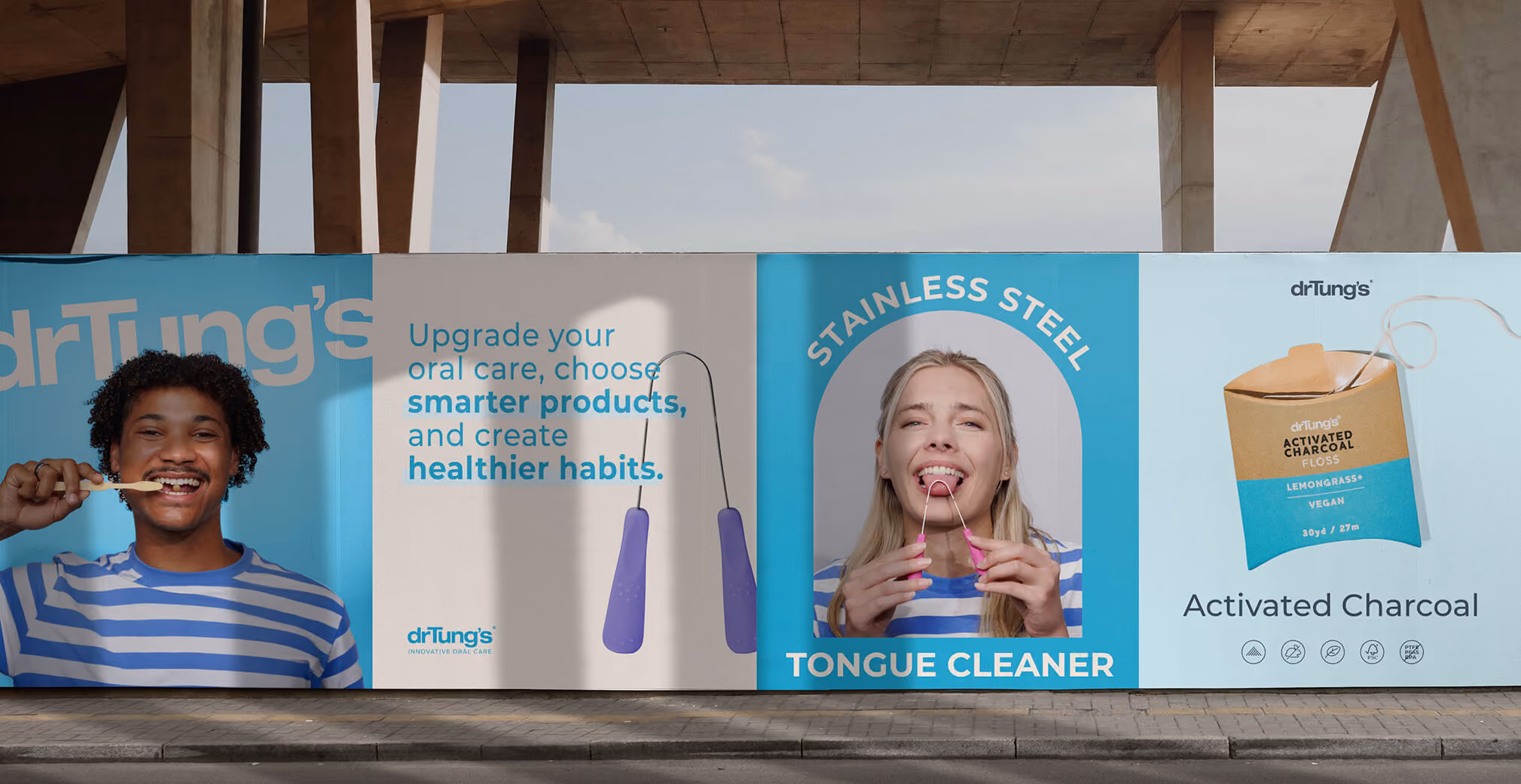 Large outdoor Dr. Tung’s billboard featuring models smiling while brushing teeth and using tongue cleaners, alongside product images and bold health-focused text.
