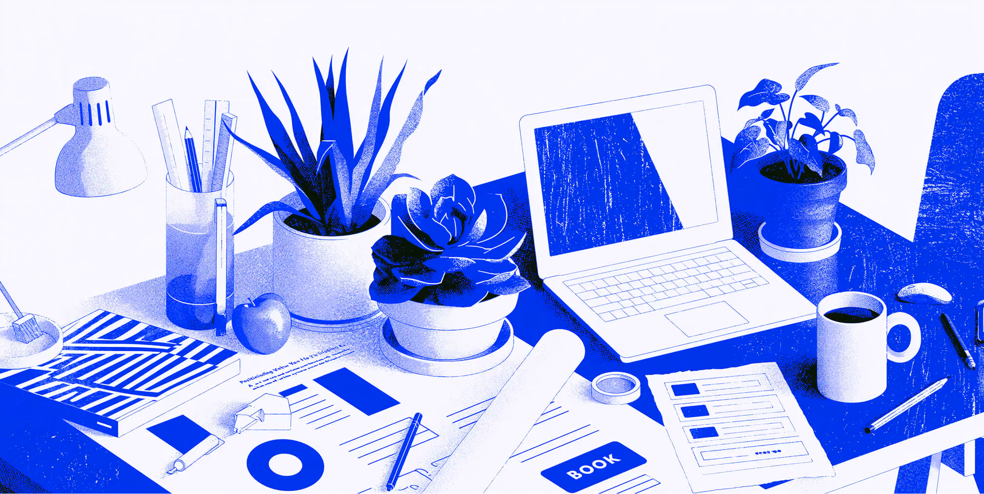 Creative workspace with laptop, design tools, and plants.