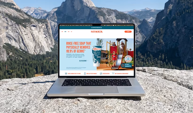 NOWATA ecommerce website displayed in the mountains.