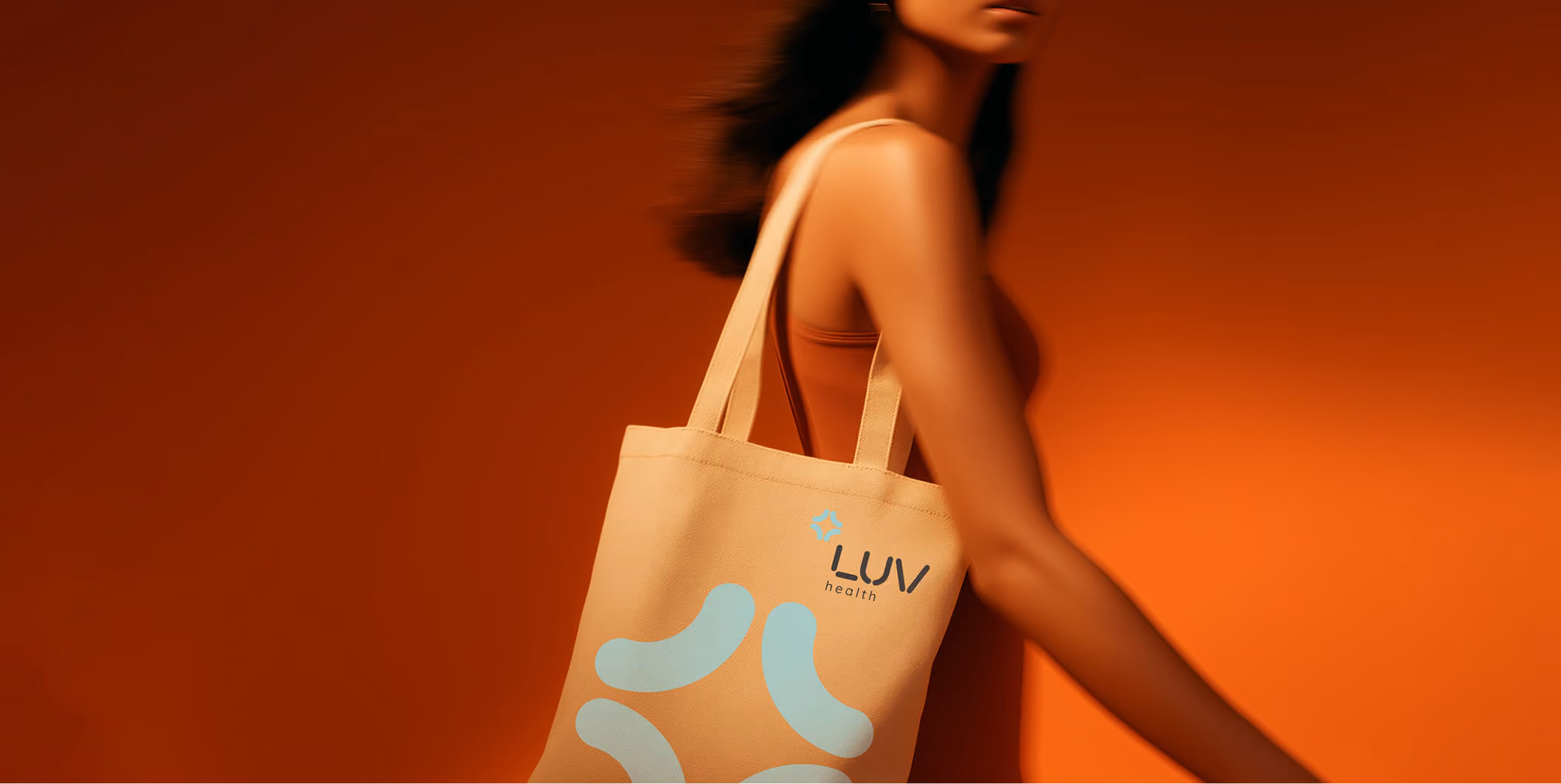 LUV Health branded tote bag in an orange studio.
