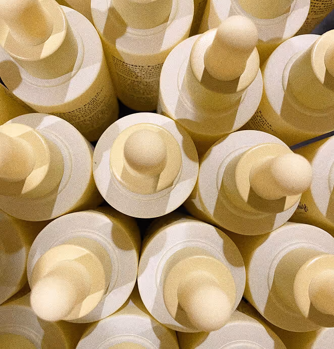 Mary Louise Miracle Serum bottles arranged in a close-up pattern with pale yellow dropper caps.