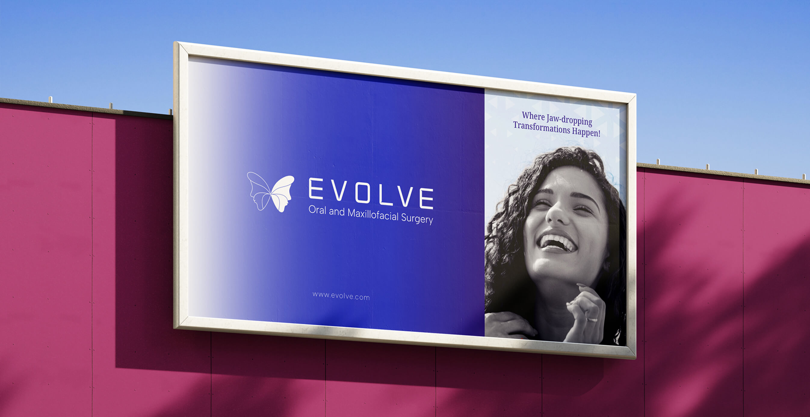 Outdoor billboard featuring the Evolve logo, butterfly icon, and a black-and-white photo of a smiling woman with the tagline “Where Jaw-dropping Transformations Happen!”