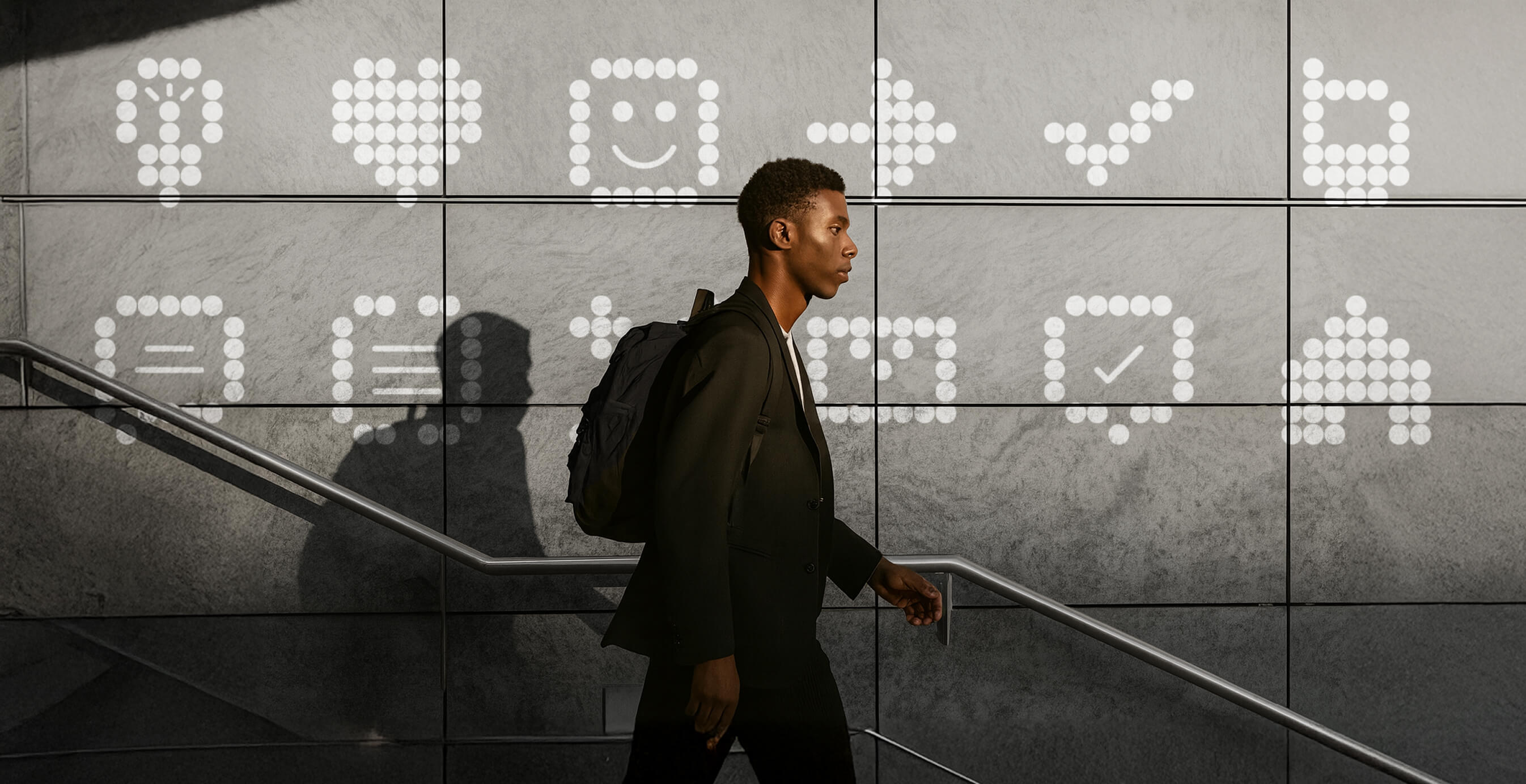 Man walking past a PepsiCo Demand Accelerator wall display with illuminated data-inspired icons.